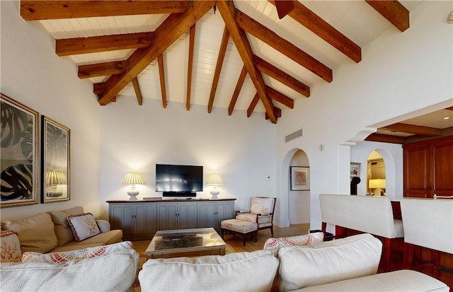 living room featuring beam ceiling, high vaulted ceiling, and dark hardwood / wood-style floors