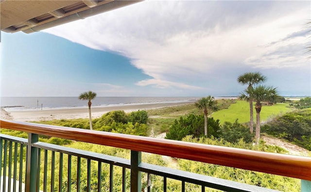 balcony featuring a water view and a view of the beach