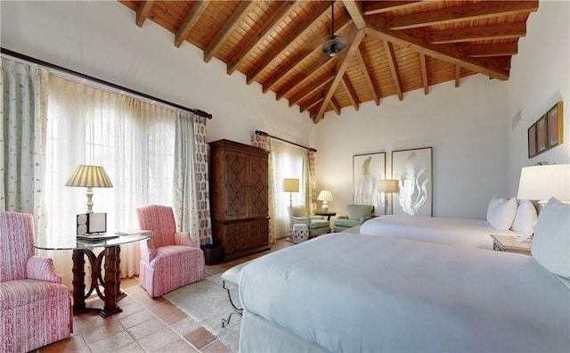 bedroom with beamed ceiling, wooden ceiling, and light tile patterned floors