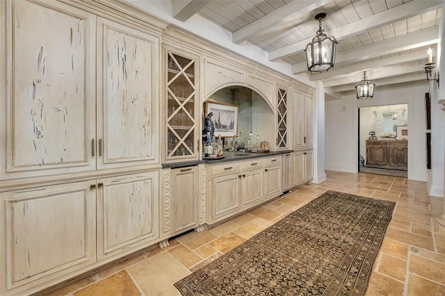 bar featuring wooden ceiling, sink, cream cabinetry, beamed ceiling, and decorative light fixtures