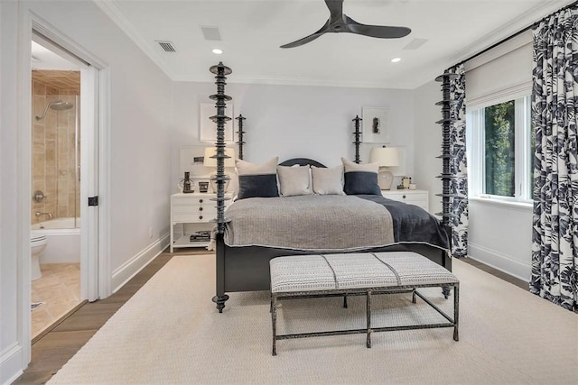 bedroom with ceiling fan, ensuite bathroom, wood-type flooring, and ornamental molding