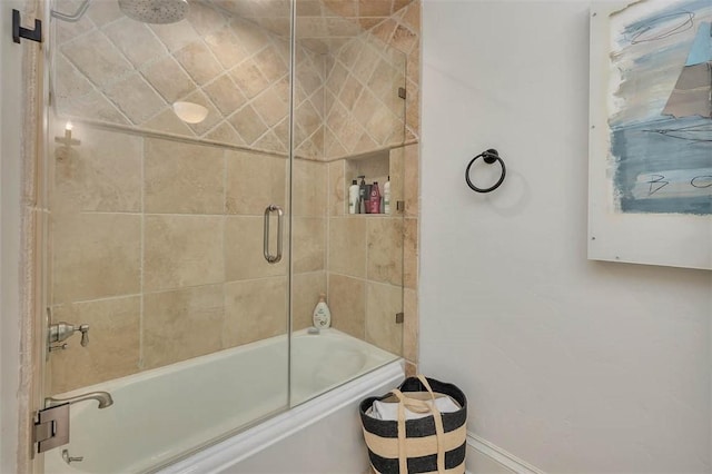 bathroom with shower / bath combination with glass door