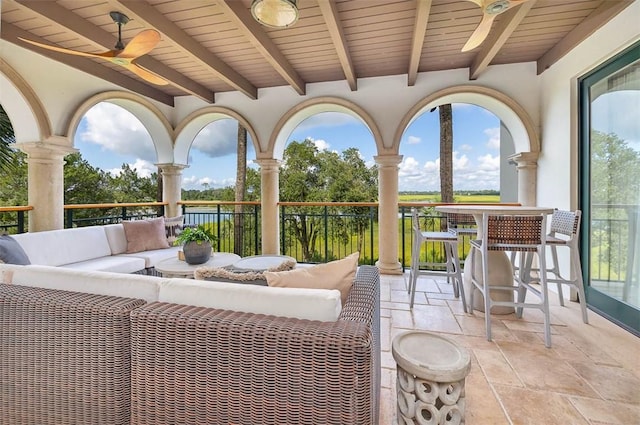 view of patio with ceiling fan, an outdoor hangout area, and exterior bar