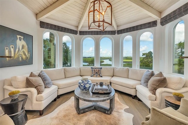 sunroom / solarium with lofted ceiling with beams, a wealth of natural light, and wood ceiling