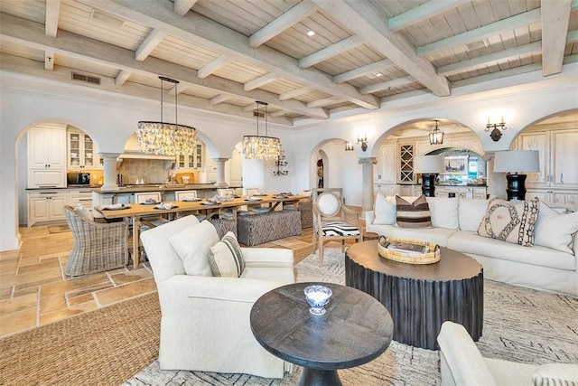 living room featuring crown molding, beamed ceiling, wood ceiling, and an inviting chandelier