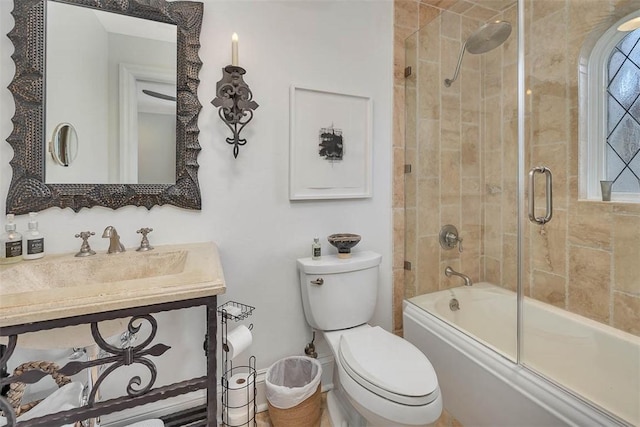 full bathroom featuring vanity, enclosed tub / shower combo, and toilet