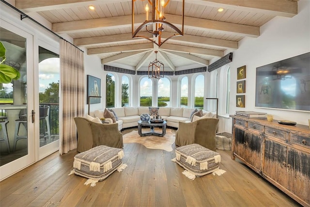 sunroom / solarium with vaulted ceiling with beams, wooden ceiling, french doors, and a chandelier