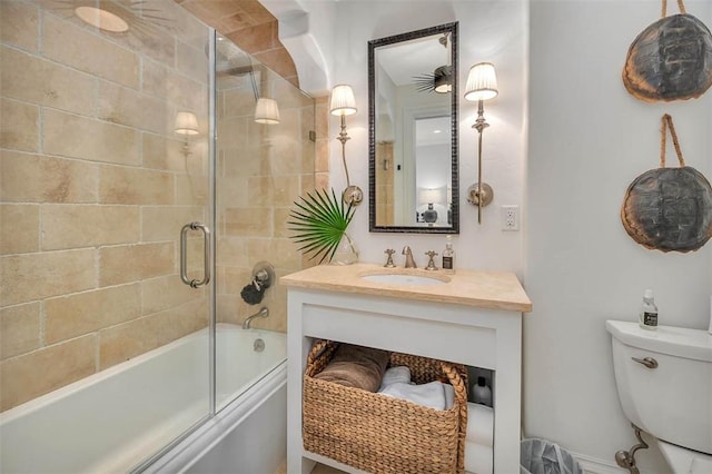 full bathroom with shower / bath combination with glass door, vanity, and toilet