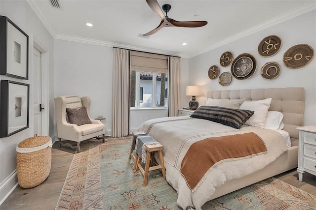 bedroom featuring hardwood / wood-style flooring, ceiling fan, and ornamental molding