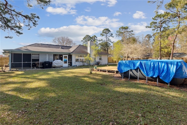 15 Merganser Way, Woodbine, GA 31569 - view of yard featuring a covered pool, fence, and a sunroom