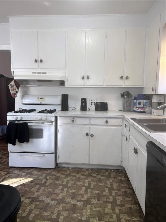 1401 Carswell Ave, Waycross, GA 31501 - kitchen with white gas range, dishwasher, under cabinet range hood, white cabinets, and light countertops
