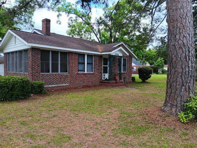 1401 Carswell Ave, Waycross, GA 31501 - view of side of property featuring brick siding, a chimney, a yard, and roof with shingles