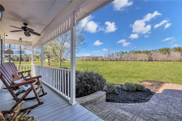 deck with a yard, a porch, and ceiling fan