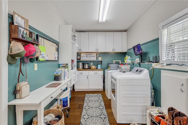 washroom featuring a textured ceiling, laundry area, wood finished floors, and washer and clothes dryer