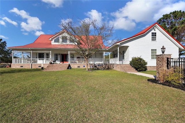 back of property with crawl space, a lawn, covered porch, and metal roof