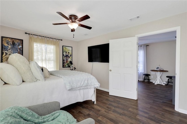 bedroom featuring baseboards, visible vents, dark wood-style flooring, and ceiling fan