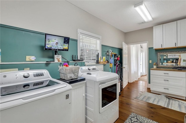 washroom featuring hardwood / wood-style floors and separate washer and dryer