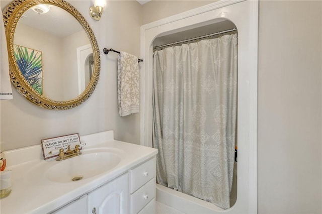 full bathroom featuring curtained shower and vanity