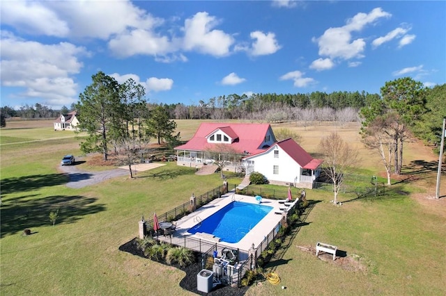 view of swimming pool featuring a lawn, a fenced backyard, and a diving board