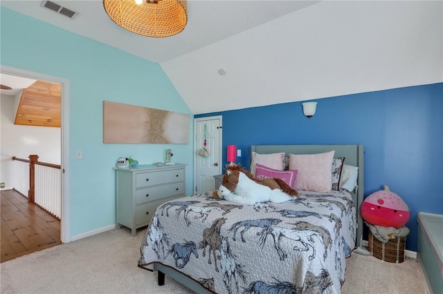 carpeted bedroom featuring visible vents, lofted ceiling, and baseboards