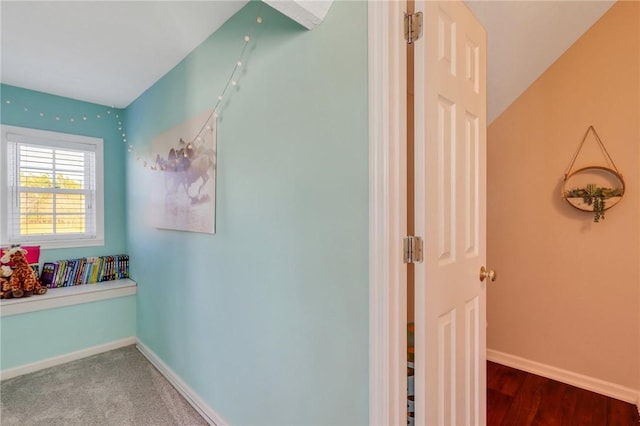 interior space with baseboards and wood finished floors