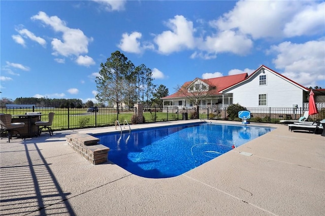 view of pool featuring a fenced in pool, fence, and a patio area