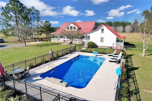 view of pool with a fenced in pool, a patio, a yard, and fence