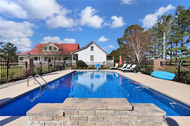 view of swimming pool featuring a patio, fence, and a fenced in pool