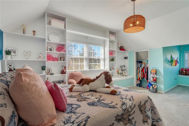 carpeted bedroom with vaulted ceiling, a spacious closet, baseboards, and a closet