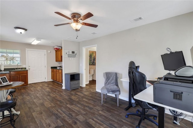 office area featuring visible vents, baseboards, ceiling fan, dark wood-style floors, and a sink