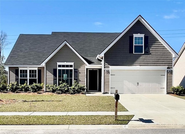 view of front facade with concrete driveway, a garage, and a front yard