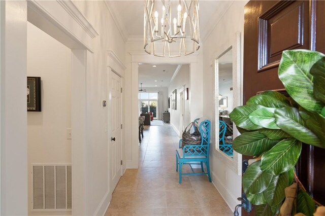 800 Ocean Blvd Unit 205, Saint Simons Island, GA 31522 - hall featuring a notable chandelier, light tile patterned flooring, and crown molding