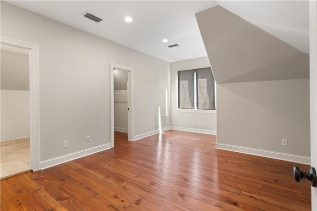 additional living space with wood-type flooring