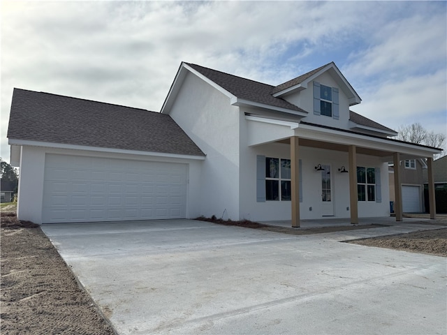 view of front facade with covered porch and a garage