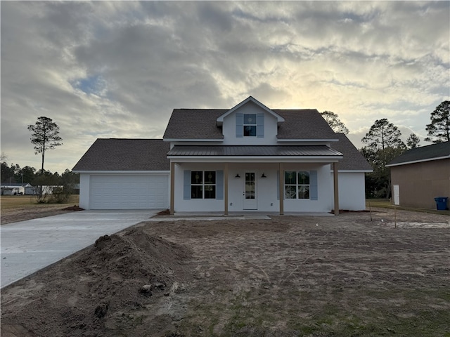 view of front facade featuring a porch and a garage