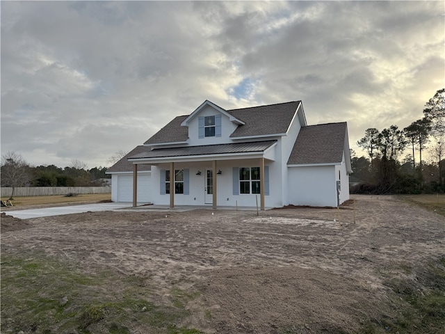 view of front of home with a porch and a garage