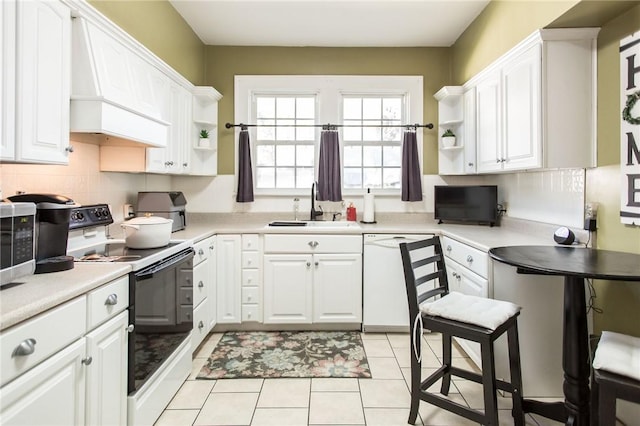 kitchen with open shelves, dishwasher, range with electric stovetop, and a sink