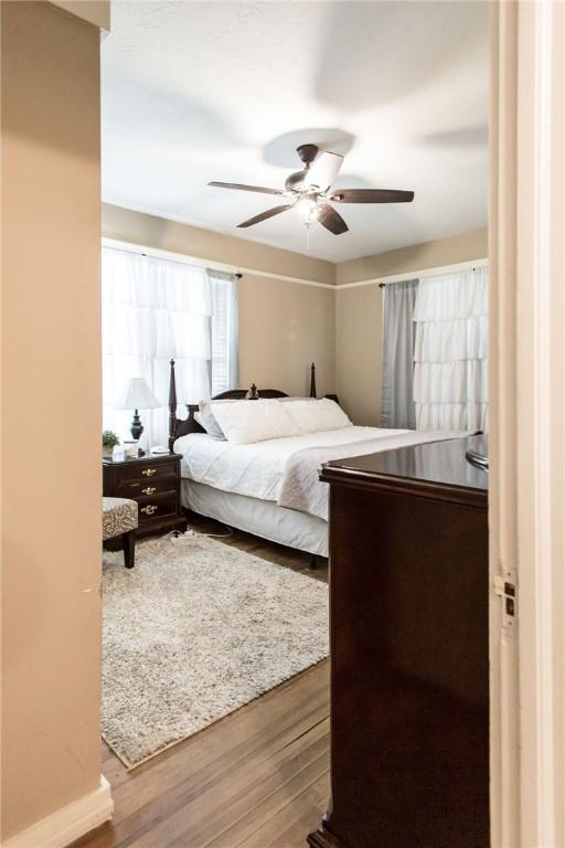 bedroom with a ceiling fan and wood finished floors
