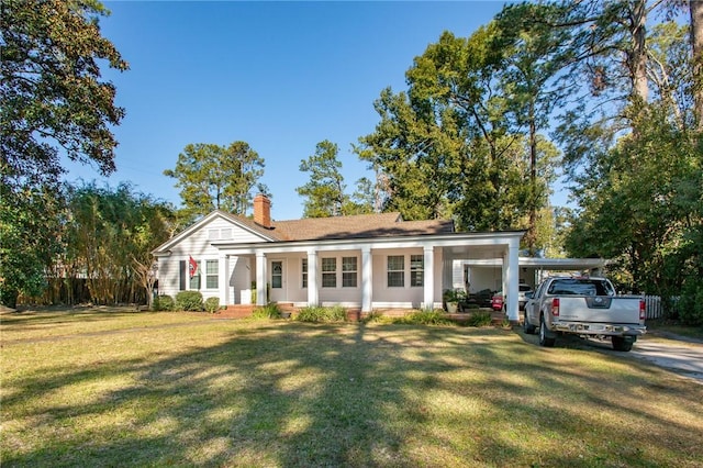 view of front of property with a chimney, a porch, a front lawn, and fence