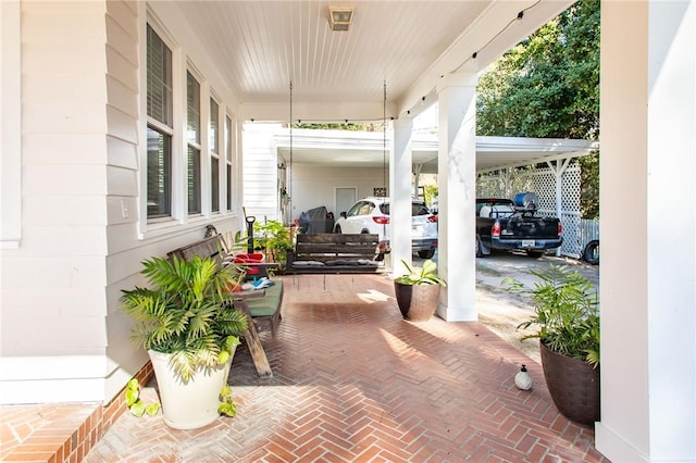 view of patio / terrace with an attached carport and covered porch