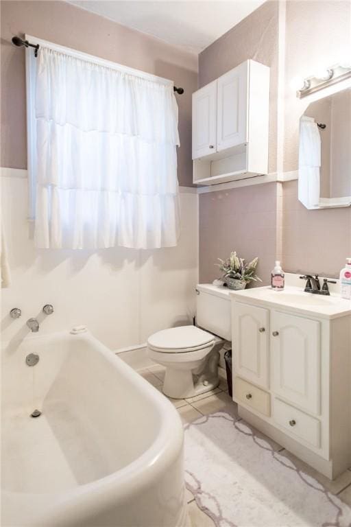 full bathroom featuring vanity, toilet, and a tub to relax in