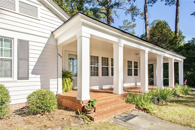 view of exterior entry featuring a porch