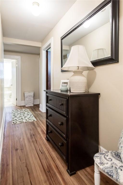hall featuring baseboards and light wood-style floors