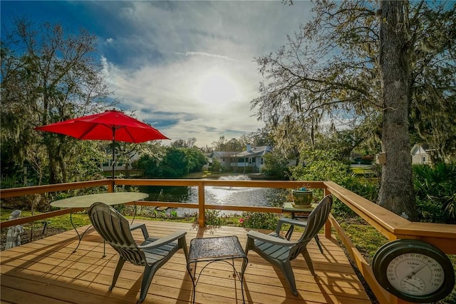 wooden terrace featuring a water view