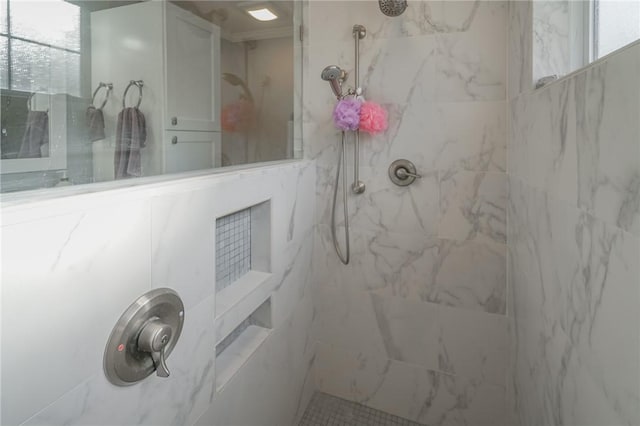 bathroom featuring a marble finish shower