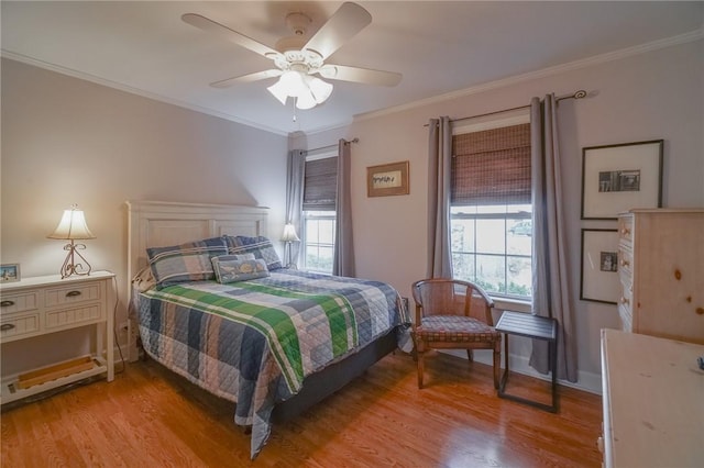 bedroom with ceiling fan, light wood-type flooring, and ornamental molding