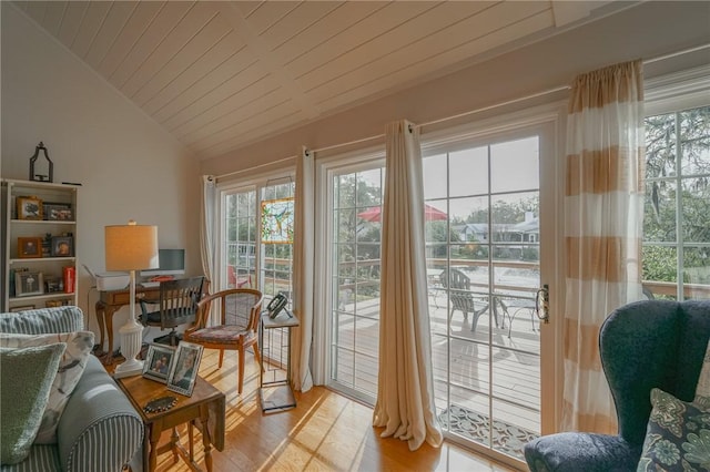 doorway with light wood finished floors, plenty of natural light, wood ceiling, and vaulted ceiling