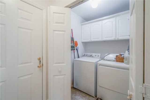 washroom with washer and dryer and cabinet space