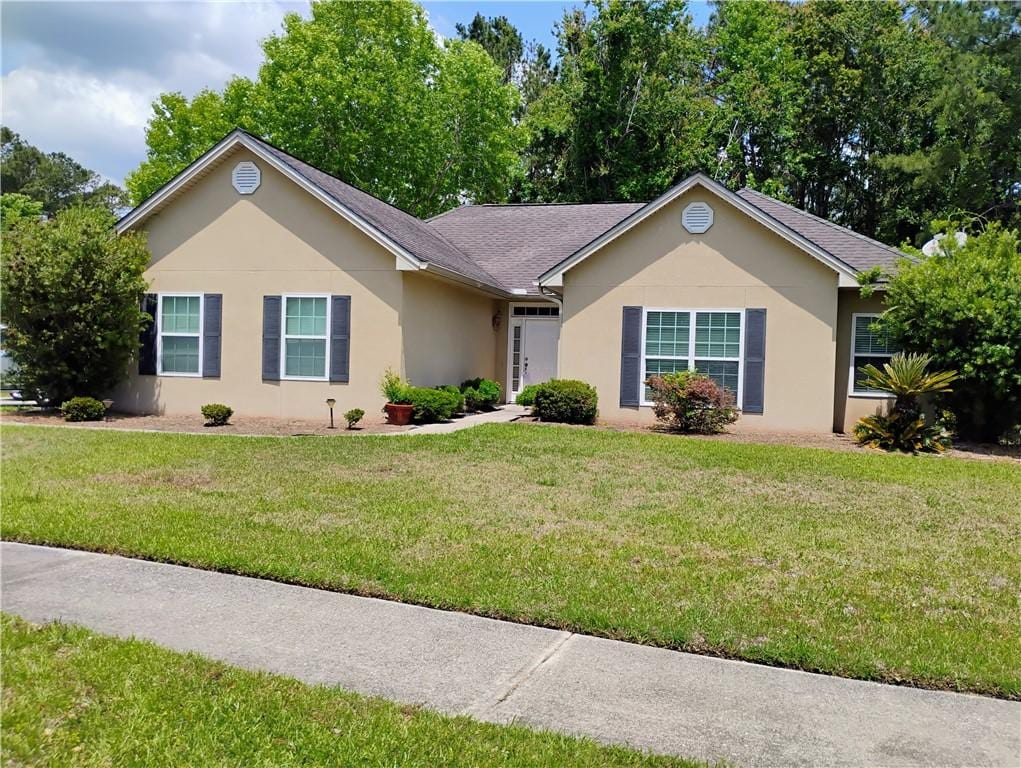 148 Hardwood Forest Dr, Brunswick, GA 31525 - ranch-style house featuring stucco siding and a front lawn
