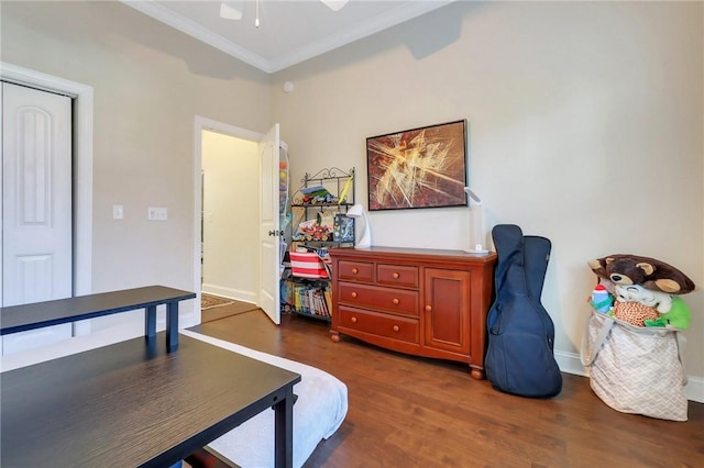 interior space featuring baseboards, ornamental molding, ceiling fan, and dark wood-type flooring